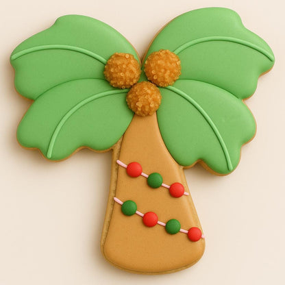 Decorated sugar cookie shaped like a palm tree with green leaves, golden coconuts, and red-and-green christmas lights.