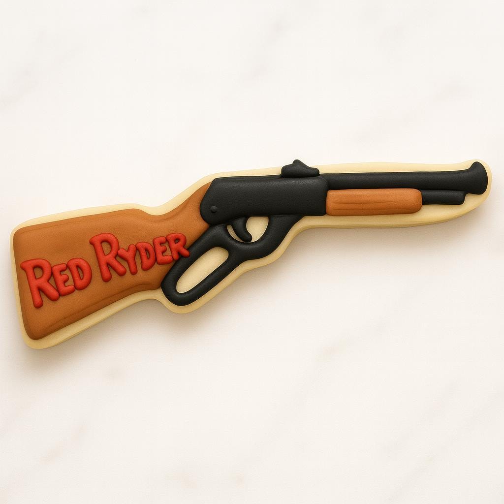 A cookie shaped like the Red Ryder BB gun from A Christmas Story, decorated with black icing for the barrel and brown icing for the wooden stock. The words “Red Ryder” appear in red icing on the side, capturing a fun, nostalgic holiday design.