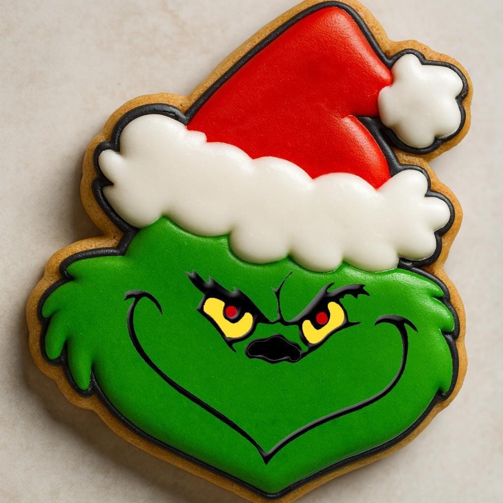 A festive cookie set inspired by The Grinch, including cookies shaped like the Grinch in a Santa hat, Max the dog with an antler, a Who girl with blonde braids and red bow, a crooked green Christmas tree with lights, and the Grinch’s green hand holding a red ornament.