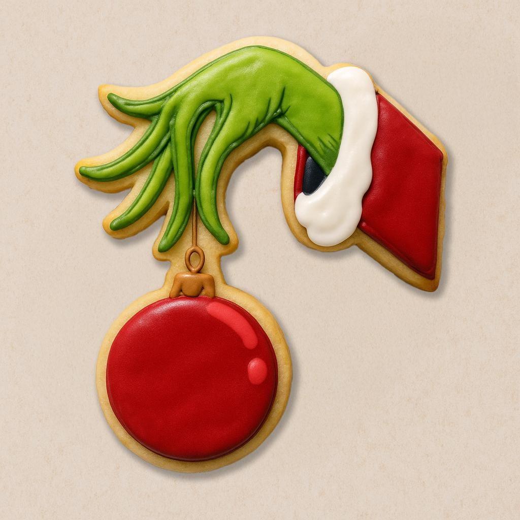 A festive cookie set inspired by The Grinch, including cookies shaped like the Grinch in a Santa hat, Max the dog with an antler, a Who girl with blonde braids and red bow, a crooked green Christmas tree with lights, and the Grinch’s green hand holding a red ornament.