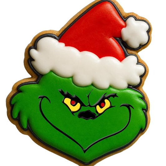 Decorated sugar cookie shaped like the grinch face wearing a red santa hat with white trim. Features green face with mischievous eyes an smirk. Perfect Christmas cookie cutter for Grinch Fans, holiday baking, christmas party treats, and festive fondant decorating.