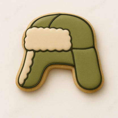 A set of decorated Christmas cookies inspired by the movie National Lampoon’s Christmas Vacation, including a car with a tree, moose mug, green trapper hat, Clark Griswold in a Santa suit tangled in lights, a roasted turkey, black cat with Christmas lights, “You Serious, Clark?” quote cookie, and an RV with a wreath.