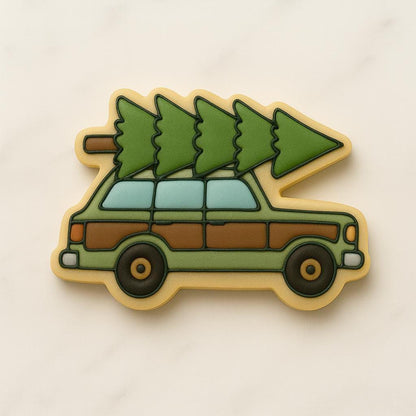 A set of decorated Christmas cookies inspired by the movie National Lampoon’s Christmas Vacation, including a car with a tree, moose mug, green trapper hat, Clark Griswold in a Santa suit tangled in lights, a roasted turkey, black cat with Christmas lights, “You Serious, Clark?” quote cookie, and an RV with a wreath.