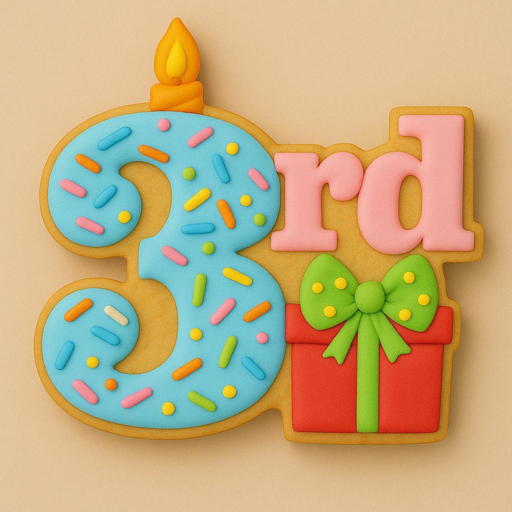 A sugar cookie shaped like the phrase “3rd,” featuring a blue number three decorated with colorful sprinkles and a small yellow candle on top, the letters “rd” in pink, and a red present with a green bow.