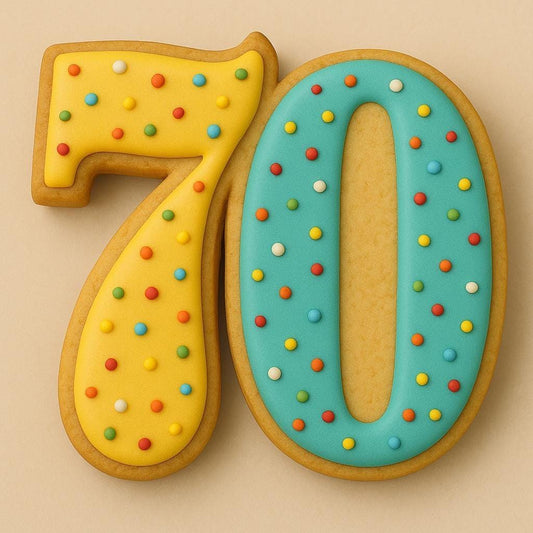 A sugar cookie shaped like the number 70, decorated with yellow and blue icing and colorful rainbow sprinkles, placed on a light beige background.